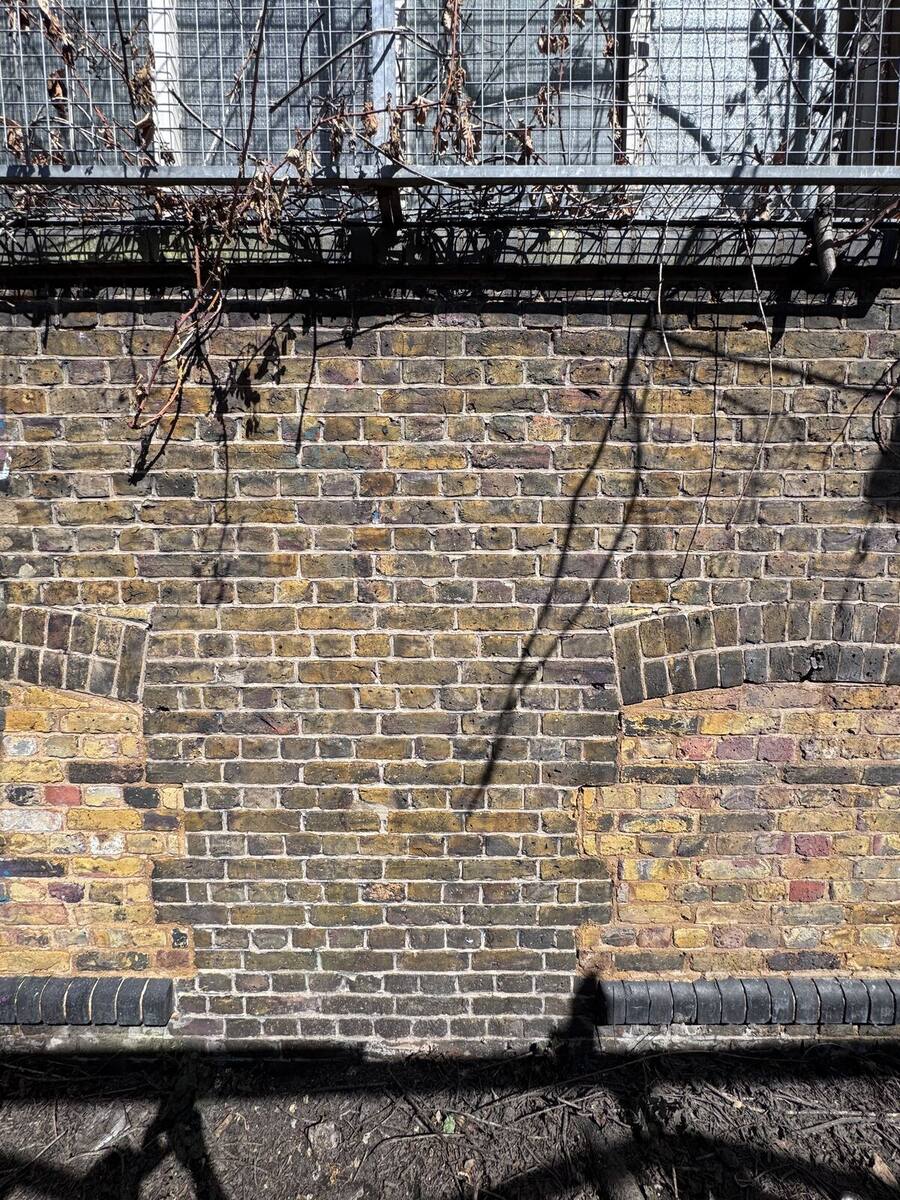 Cleaned London stock brick wall after graffiti removal