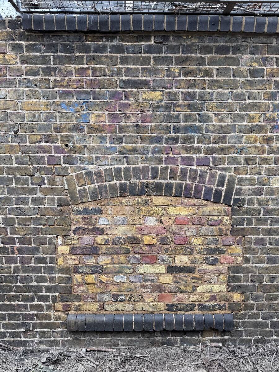 Gauged brick arch detail visible again after paint removal and cleaning